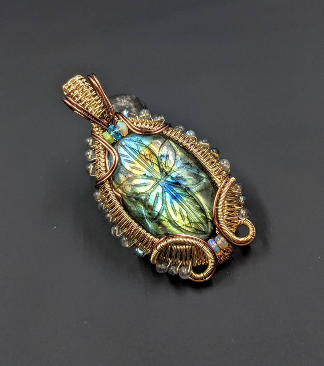 Carved Labradorite wire wrapped pendant with Welo Opal and Apatite